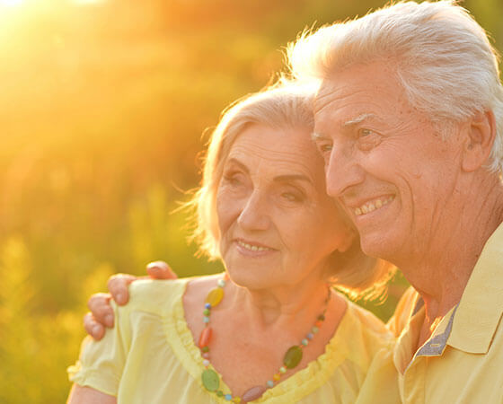 No-Cost Pre-Planning Available text over Couple smiling in sunlight